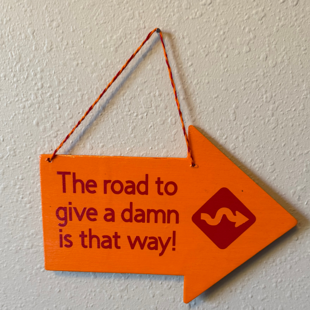 The Road To Give A Damn Is That Way Sign